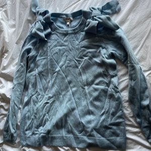 100% cashmere Tyler Boe light blue sweater with bows on the shoulders